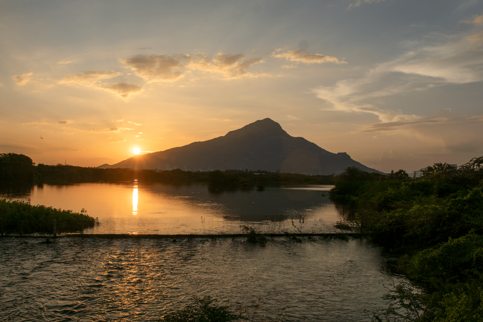 Arunachala Hill at sunset with water reflection